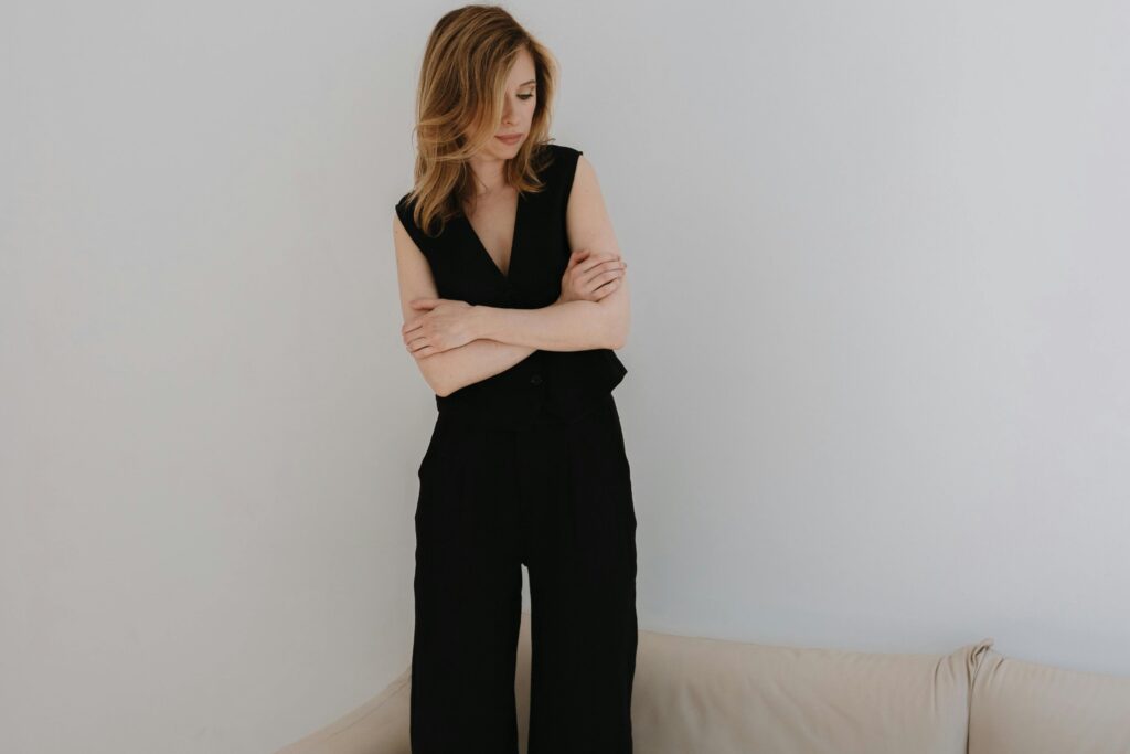 An image of a woman wearing elegant tailored vest and trousers in black colour